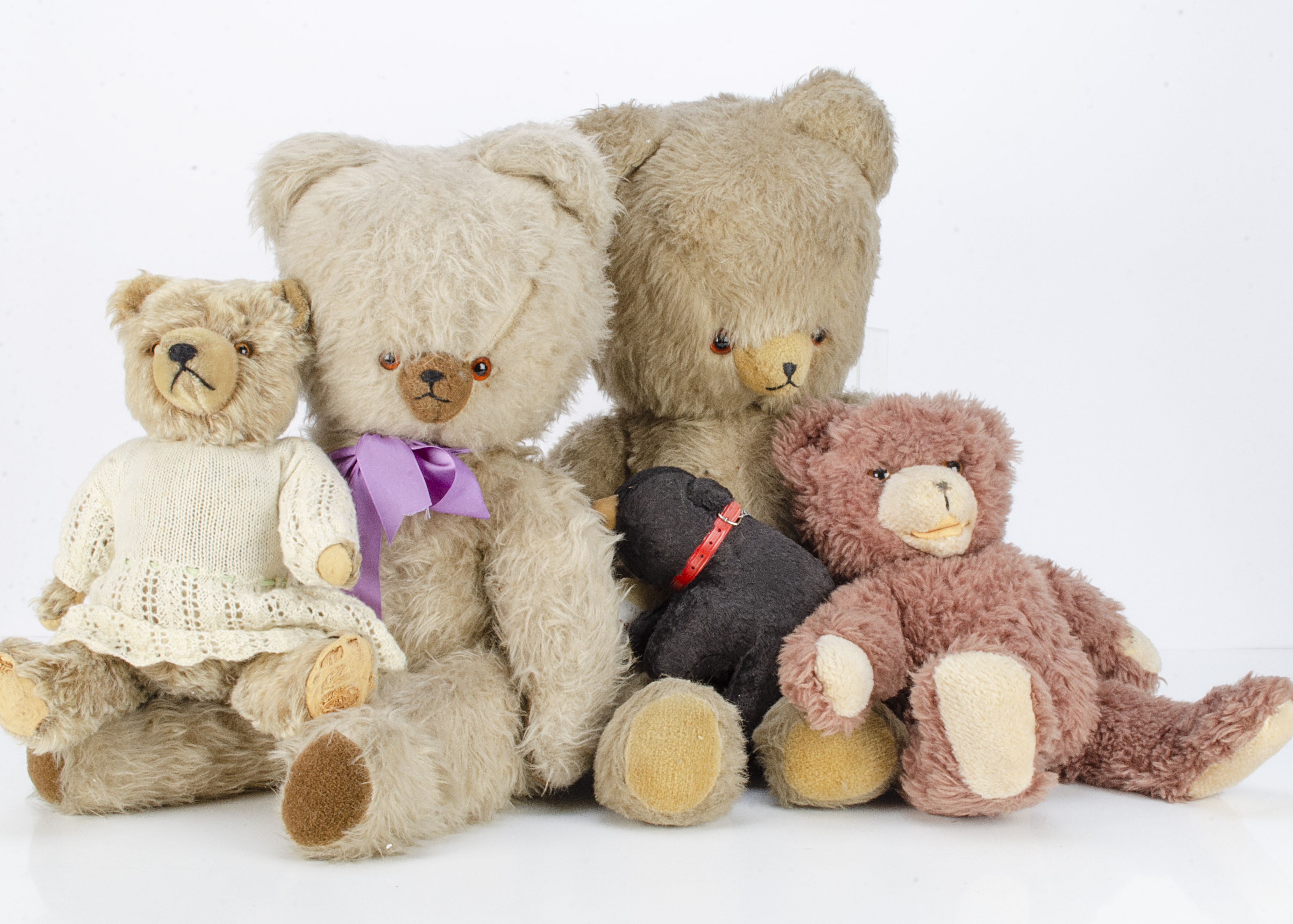 Four post-war Continental teddy bears, a Hermann type in knitted dress --15in. (38cm.) high; a brown