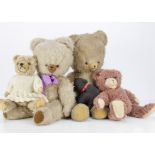 Four post-war Continental teddy bears, a Hermann type in knitted dress --15in. (38cm.) high; a brown