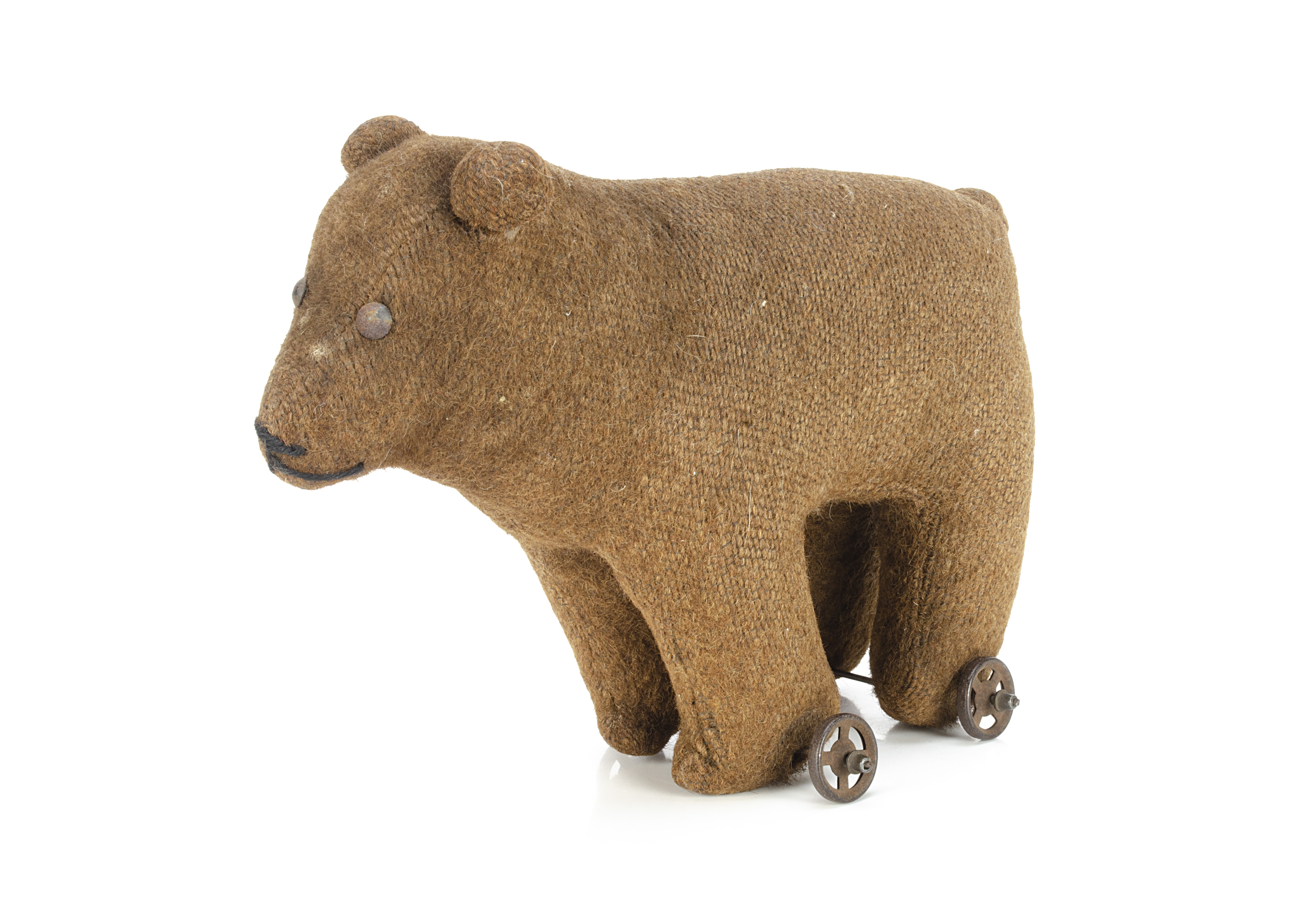 An early brown burlap bear on wheels, probably British with tinplate eyes, pronounced muzzle,