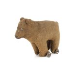 An early brown burlap bear on wheels, probably British with tinplate eyes, pronounced muzzle,