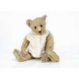 A Steiff teddy bear circa 1907, with blonde mohair, black boot button eyes, pronounced clipped
