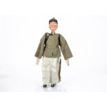 An unusual Chinese Opera male doll in civilian dress, with moulded composition head with white