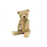 A Chiltern-type teddy bear 1930s, with golden mohair, clear and black glass eyes, black stitched