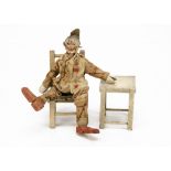 A larger Schoenhut Circus clown, with printed costume --8in. (20.5cm.) high; a chair and a stool (