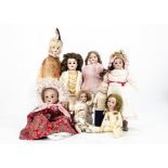 Eight various bisque headed dolls, one marked 2000 with jointed composition body --14in. (35.5cm.)