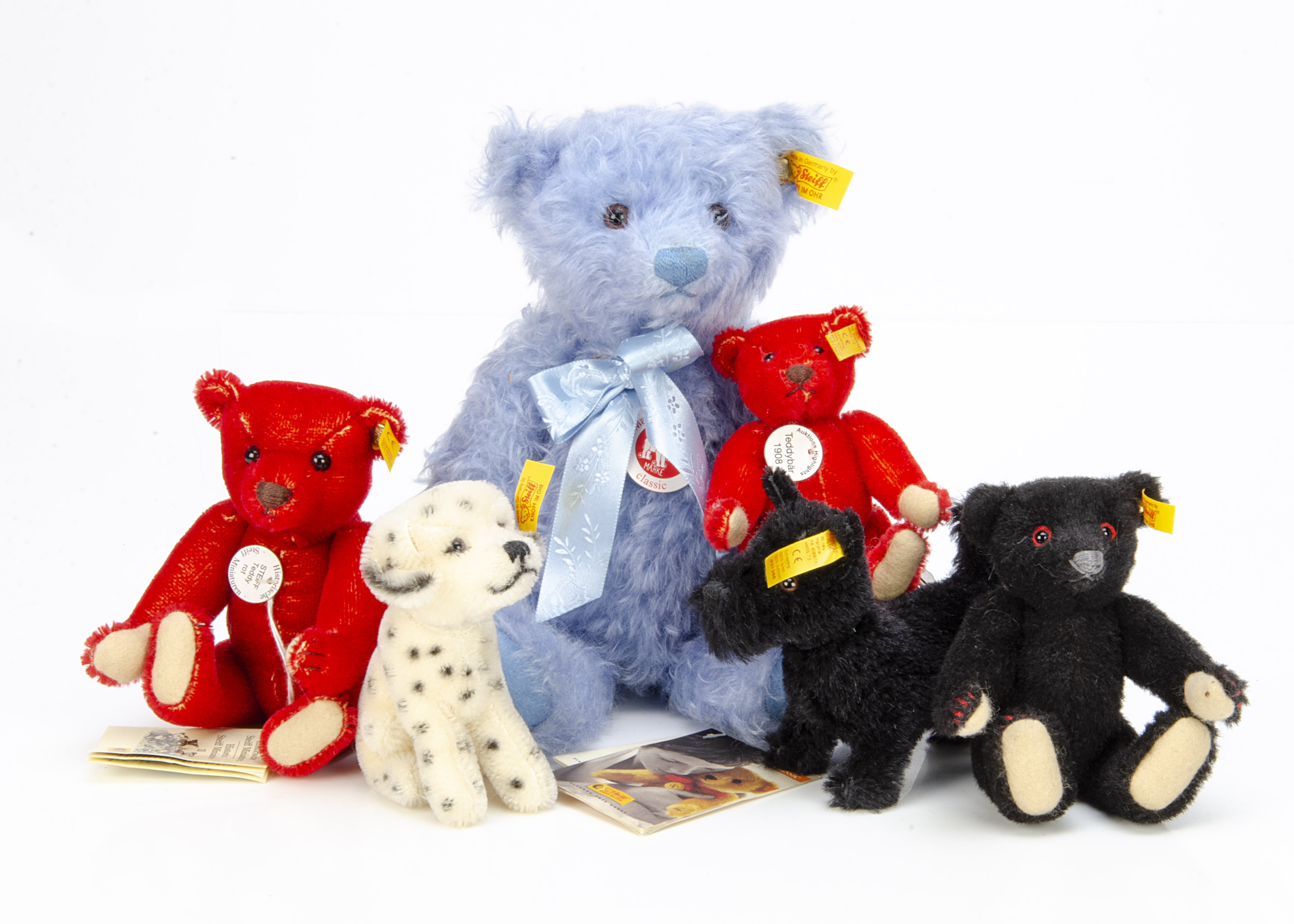 Six Steiff yellow tagged teddy bears and dogs, two red, one pale blue --11in. (28cm.) high, a