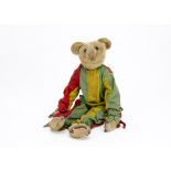 A very rare and early Strunz jester teddy bear circa 1904, probably rod jointed with blonde mohair