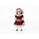 An all-bisque dolls' house doll, with dark glass eyes, blonde mohair wig, fixed neck, jointed