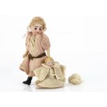A German bisque headed dolls' house doll, with dark glass eyes, blonde mohair wig, jointed