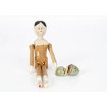 The Smallest Doll in the World, jointed wooden miniature doll, in turned wooden blue egg --1 ¼in. (