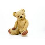 A post-war Chad Valley teddy bear, with golden mohair/mixed plush, orange and black plastic eyes,