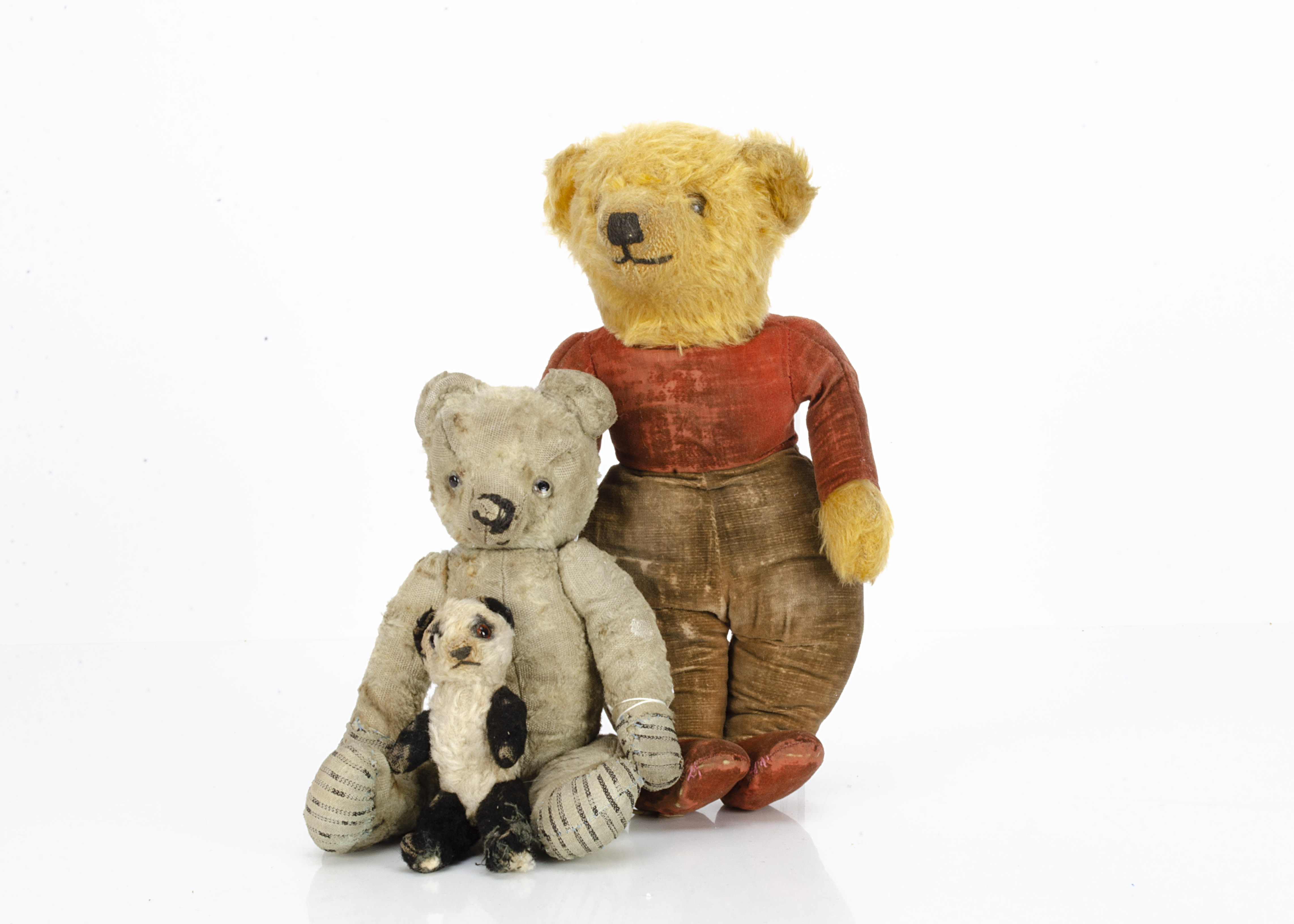 Three 1930s British teddy bear, a small black and white artificial silk plush panda, probably