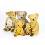 Three post-war Dean's teddy bears, a light brown wool plush jointed bear with plastic eyes, velvet