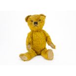A good British teddy bear late 1930s, with bright golden mohair, clear and black glass eyes with