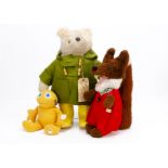 A Gabrielle Designs Paddington Bear, in green duffle coat with card tag and yellow Dunlop