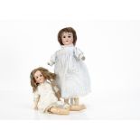 Two Armand Marseille Floradora dolls, the larger with brown sleeping eyes, brown mohair wig, jointed