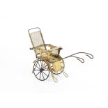 A painted tinplate doll's push chair, probably French with reclinable back, mesh back and sides,