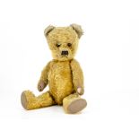 A Pixie Toy teddy bear 1950s, with golden mohair, orange and black glass eyes, black stitched