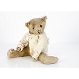 An early American teddy bear circa 1910, with light golden mohair, black boot button eyes,