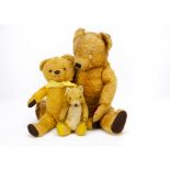 Two Merrythought teddy bears, a unusual yellow artificial silk plush seated teddy bear with white