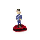 A 19th century bisque soldier boy pen wipe, with blue painted eyes, blonde hair and blue uniform,