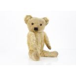 A 1930s Merrythought teddy bear, with blonde mohair, orange and black glass eyes, pronounced