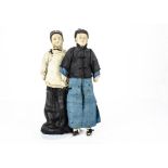 Two interesting early 20th century Chinese silk dolls, with moulded faces, painted features, yarn