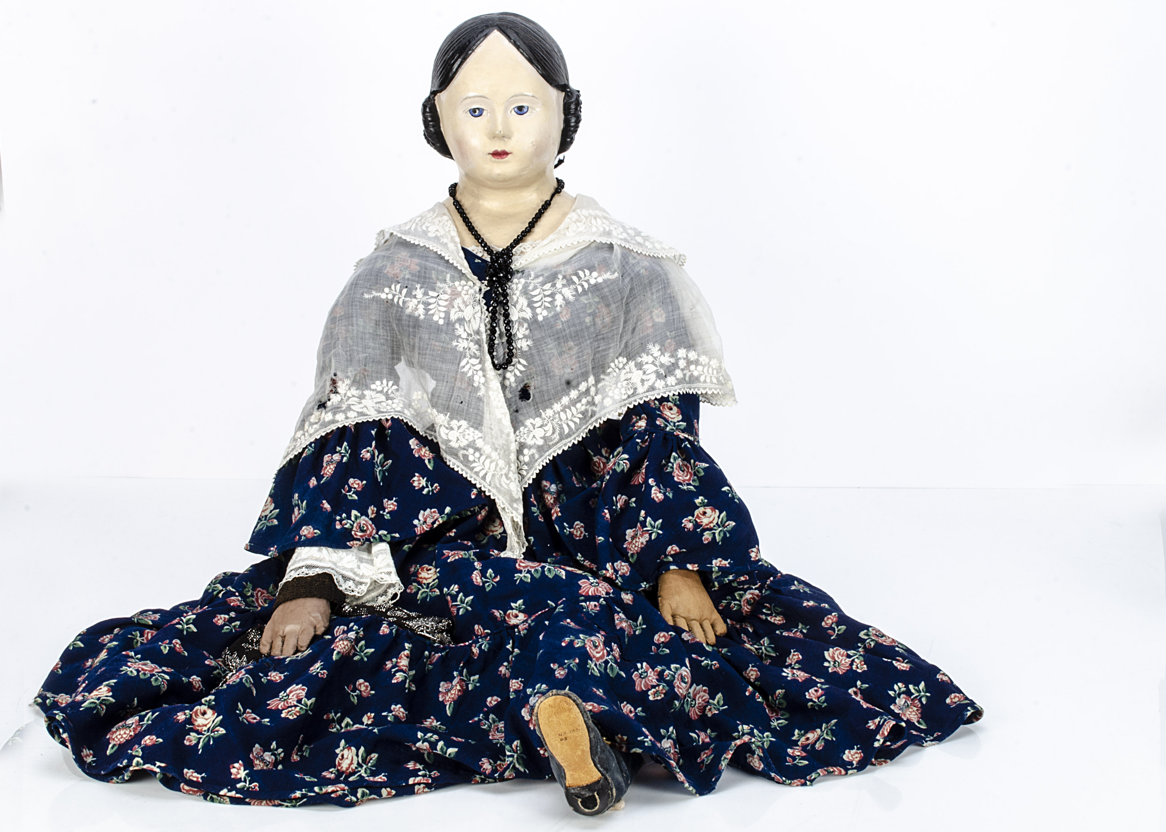A very large papier-mâché Grenier type shoulder-head doll, with blue painted eyes, black painted