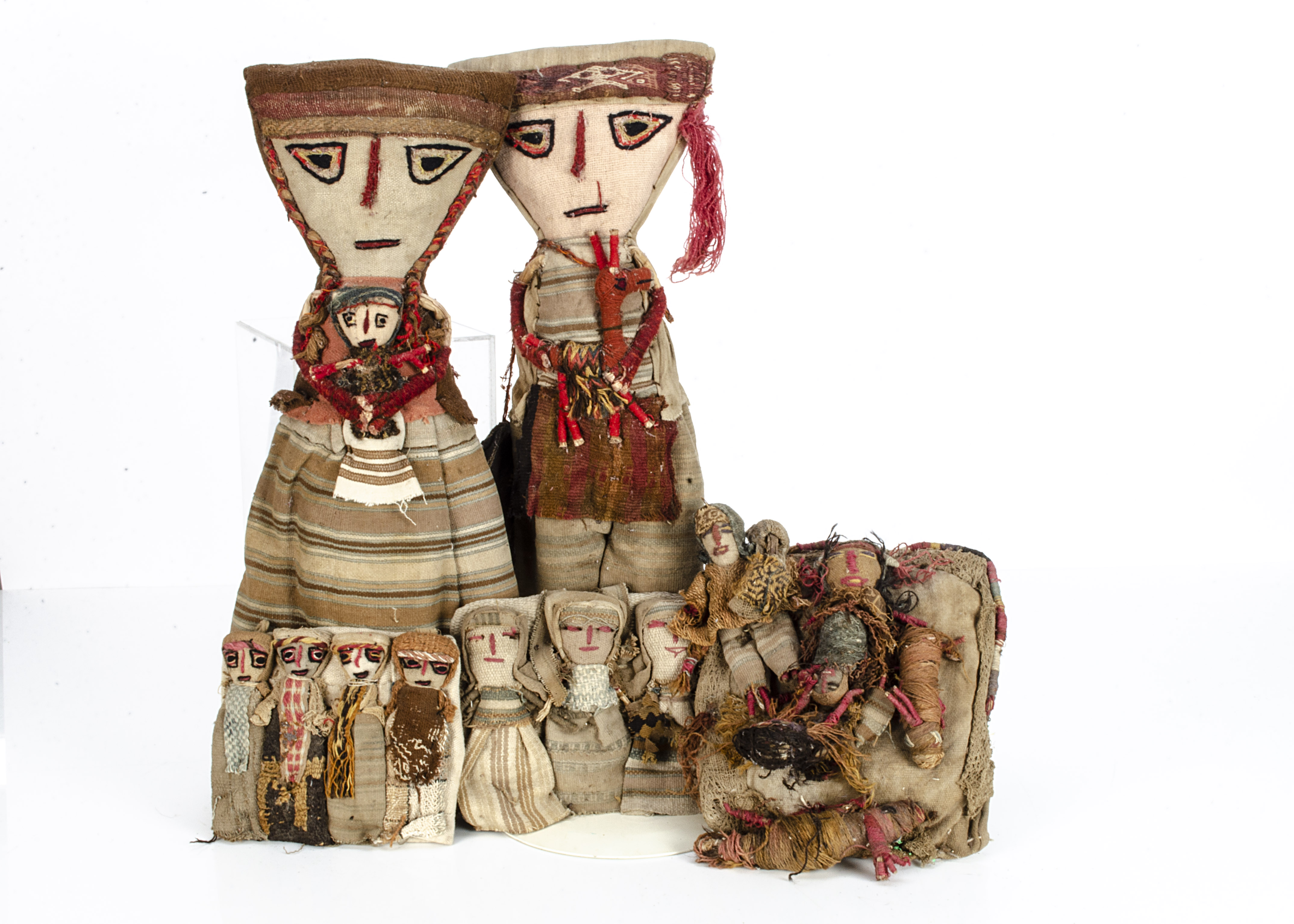 Five Peruvian Chancay dolls, a large couple, her holding a baby and him a llama --20 ½in. (52cm.)