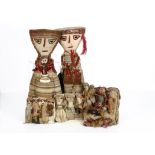 Five Peruvian Chancay dolls, a large couple, her holding a baby and him a llama --20 ½in. (52cm.)