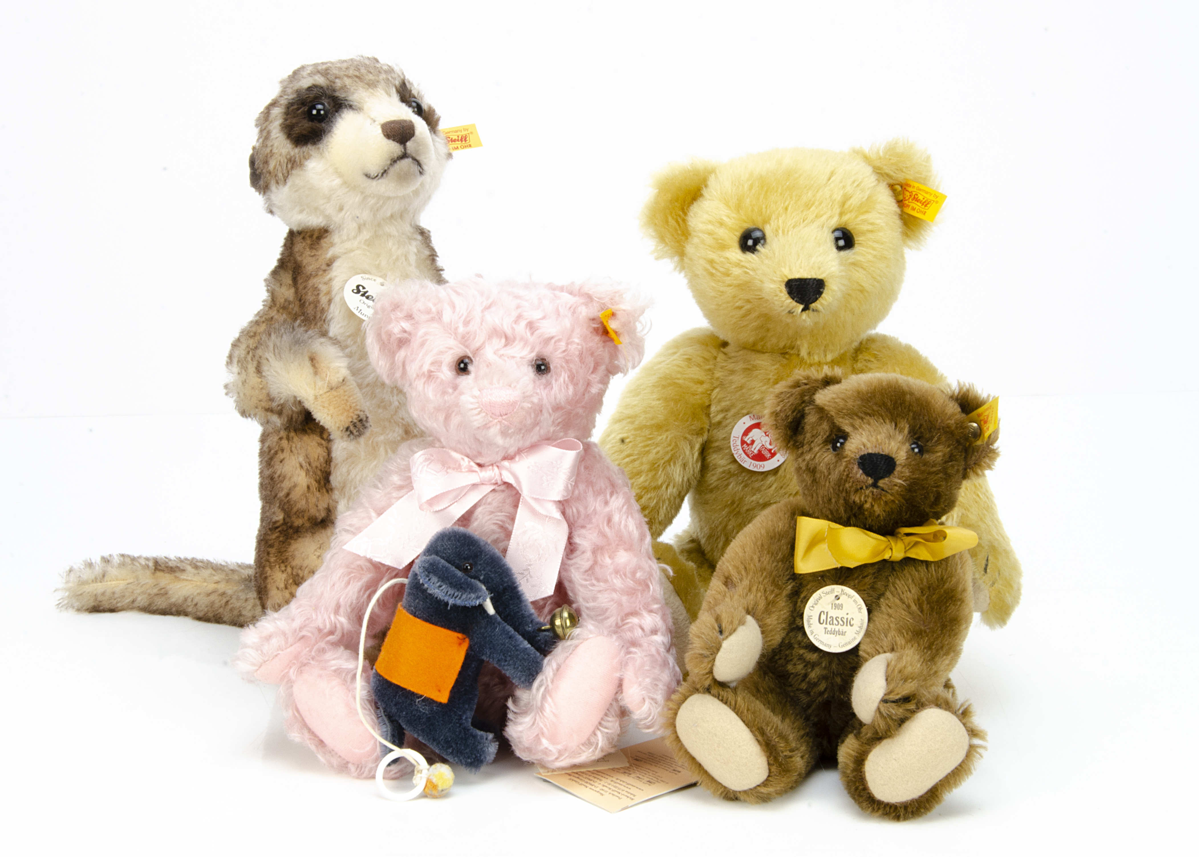 Three Steiff yellow tagged teddy bears, and a Mungo meercat --12 ½in. (32cm.) high; and a Steiff