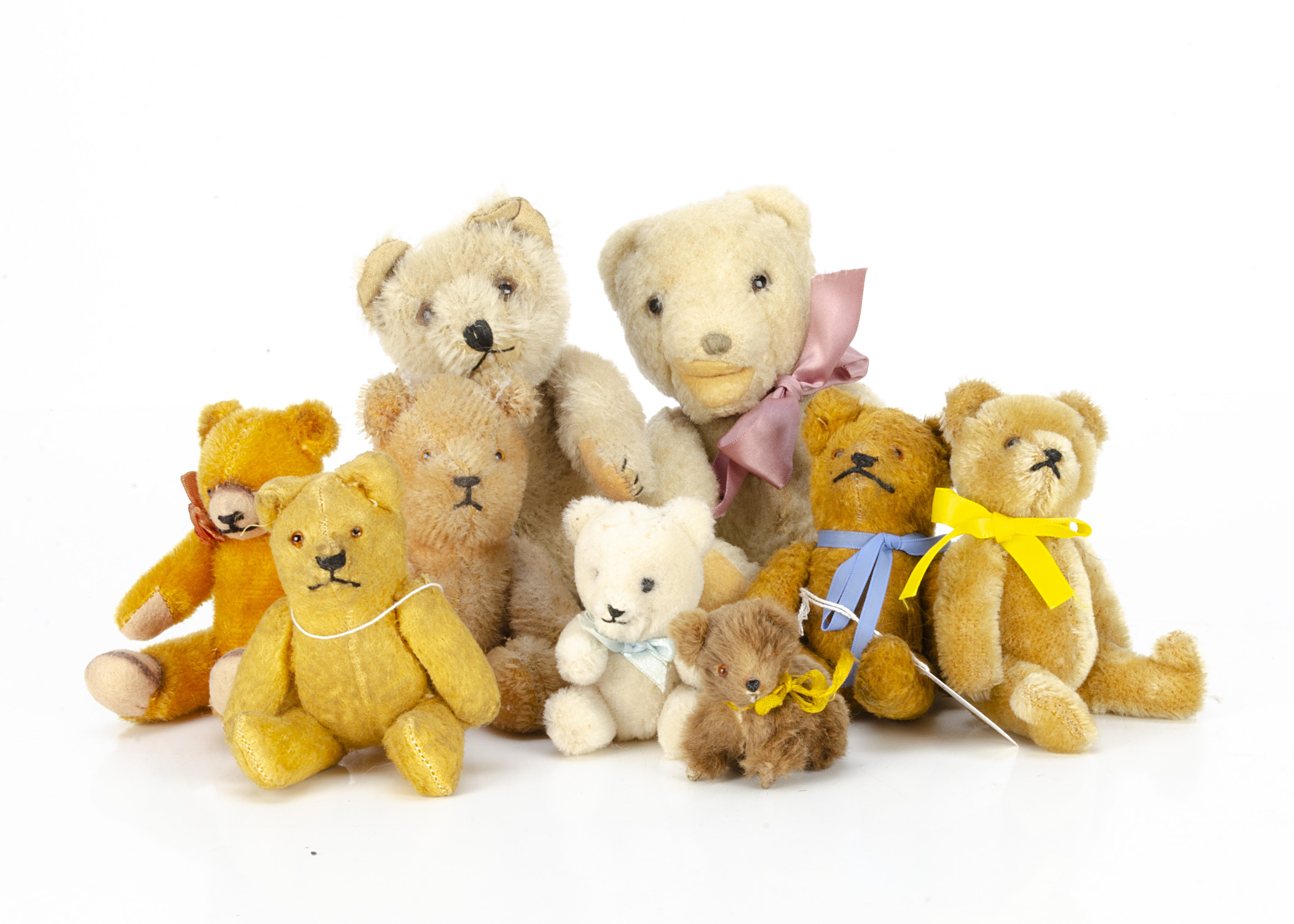 Nine small teddy bears, a Hamiro white wool plush teddy baby --9in. (23cm.) high; a post-war