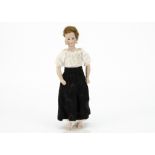 An unusual German bisque shoulder-head lady doll marked 411, with fixed brown glass eyes, closed