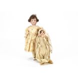 A small German bisque headed doll marked 24 K1, with blue sleeping eyes, brown mohair wig,