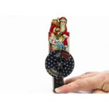 A German lithographed tinplate Father Christmas spark toy, with push action causing a wheel to