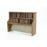 An unusual toy book case, probably circa 1900 of painted wood and cardboard with over fifty dummy