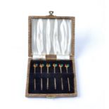 A cased set of six polychrome enamelled silver cockerel cocktail sticks, in faux snakeskin case,