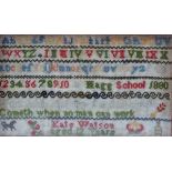 An Edwardian school sampler, worked in brightly coloured wools on a canvas ground, with cases of the