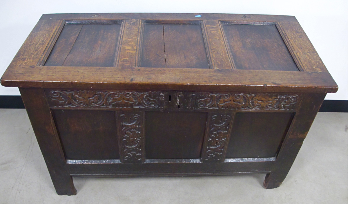 An antique oak three panelled coffer with carved frieze, some later alterations including a