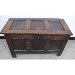 An antique oak three panelled coffer with carved frieze, some later alterations including a