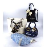 Four designer handbags, including a DKNY white bag decorated with a scarf, in the original velour