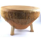 A large hide African drum on three legs, no obvious tears. Diameter 76cm.