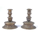 A pair of 19th Century cast bronze candlesticks with a design of Satyr's heads foliage and grape