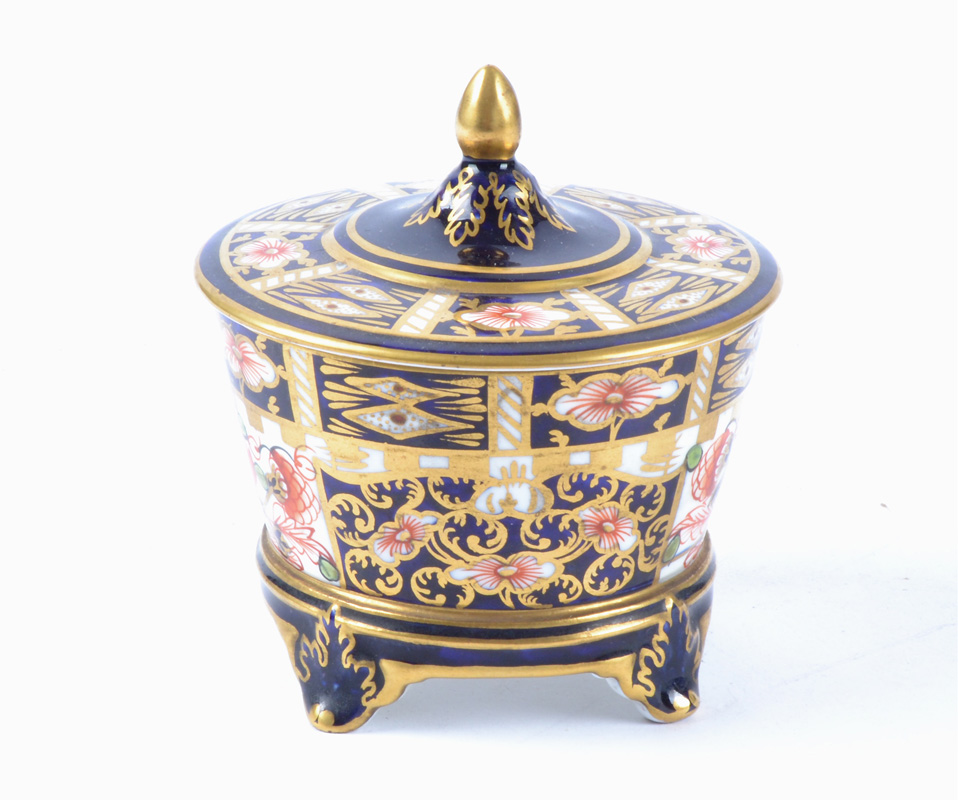 A Royal Crown Derby Imari lidded storage pot decorated in the 6299 pattern, raised on four feet with