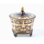 A Royal Crown Derby Imari lidded storage pot decorated in the 6299 pattern, raised on four feet with