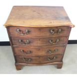 An antique mahogany serpentine chest, of four long drawers, shaped moulded top, brass carrying