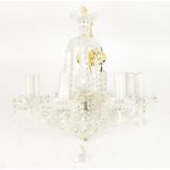 A contemporary glass chandelier, of eight branched form, supporting floral bowls with faceted