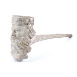 A white clay smoker's pipe, the bowl decorated with carving of a gentleman's face wearing a cap