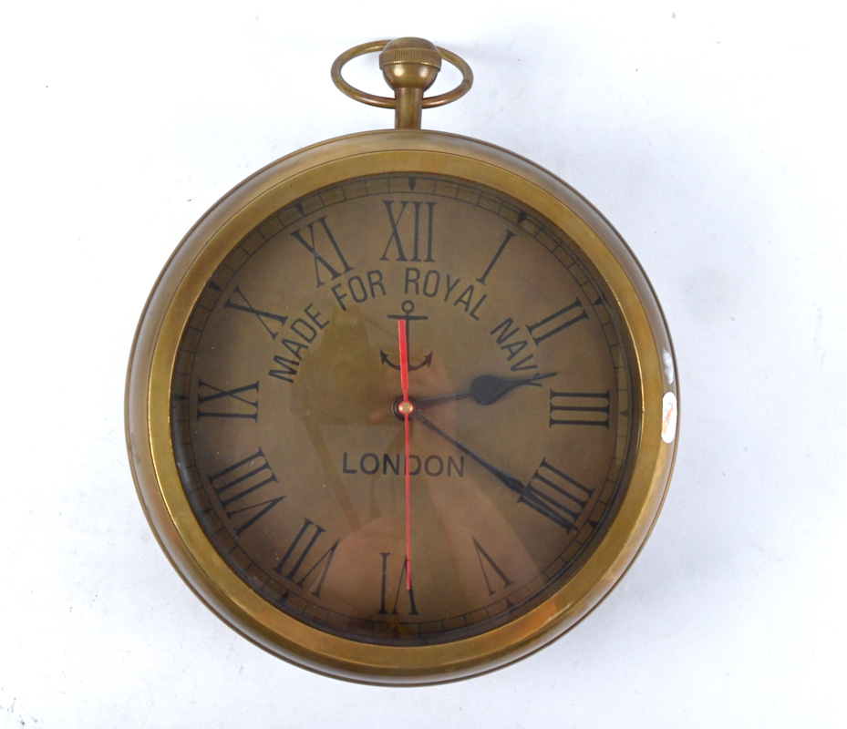 An oversized Brass hanging clock in the form of a pocket watch, with faces to both sides, each