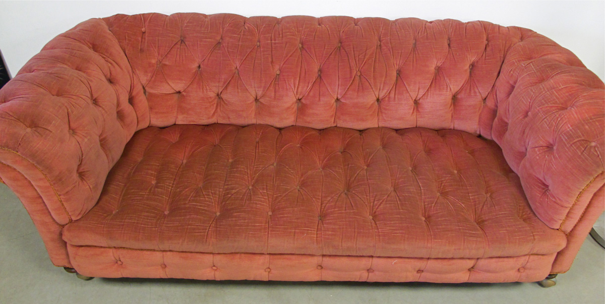 A button back Chesterfield sofa, upholstered in rose fabric, with gold braiding, with replacement